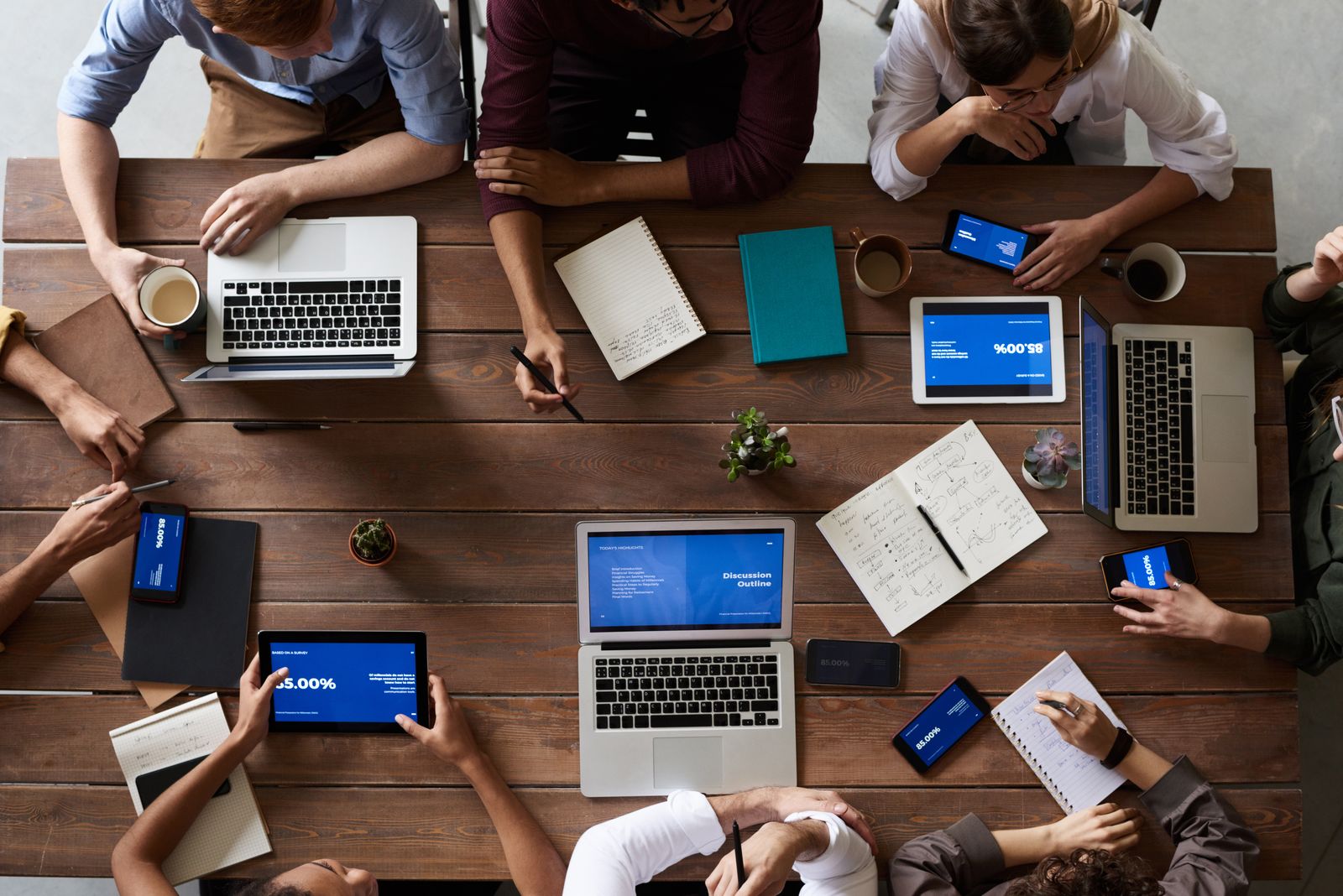 An overhead view of a collaborative planning session with laptops and documents